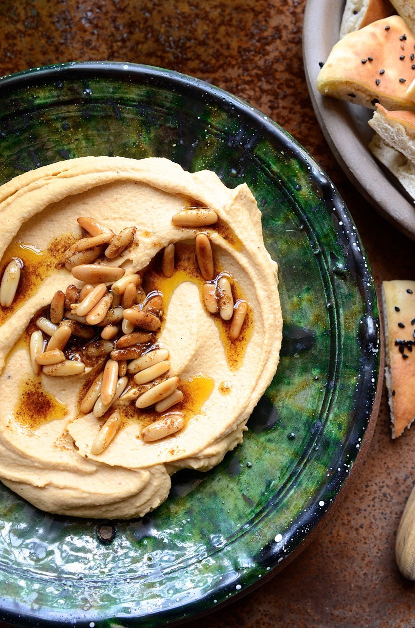 Ultra smooth hummus with harissa pine nut oil